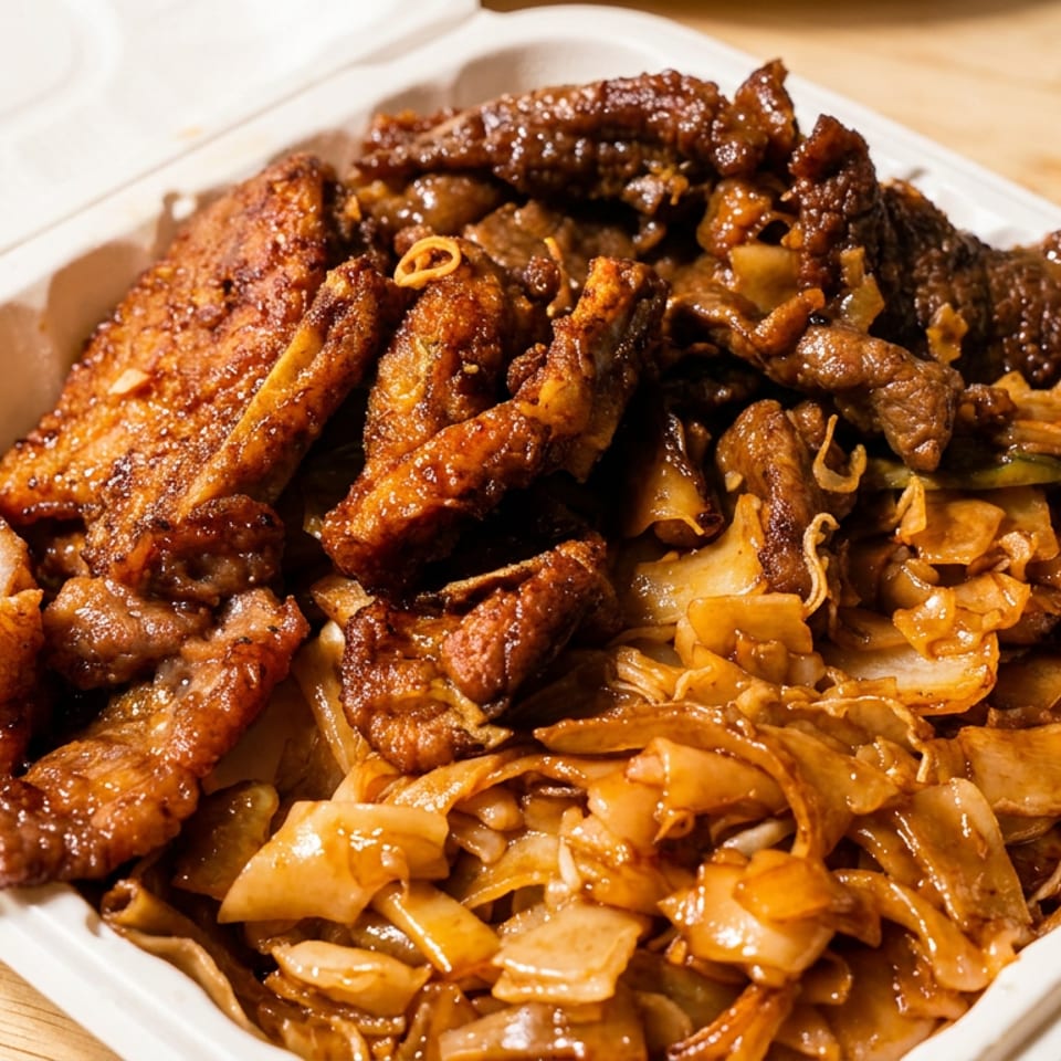 Takeout container filled with assorted grilled meats and saucy stir-fried vegetables on a wooden table.